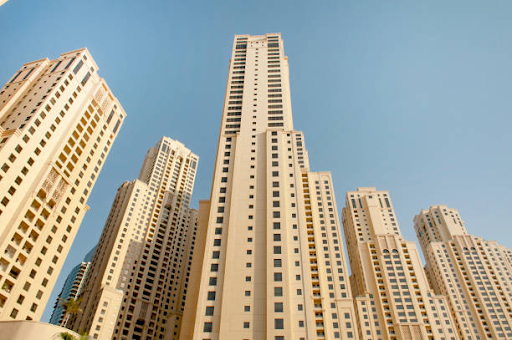 Tall, modern skyscrapers near Binghatti Hills with recreational amenities around the area.